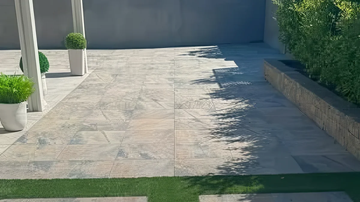 Light large-format stone patio in full Las Vegas sun, a pale surface that stays cool underfoot