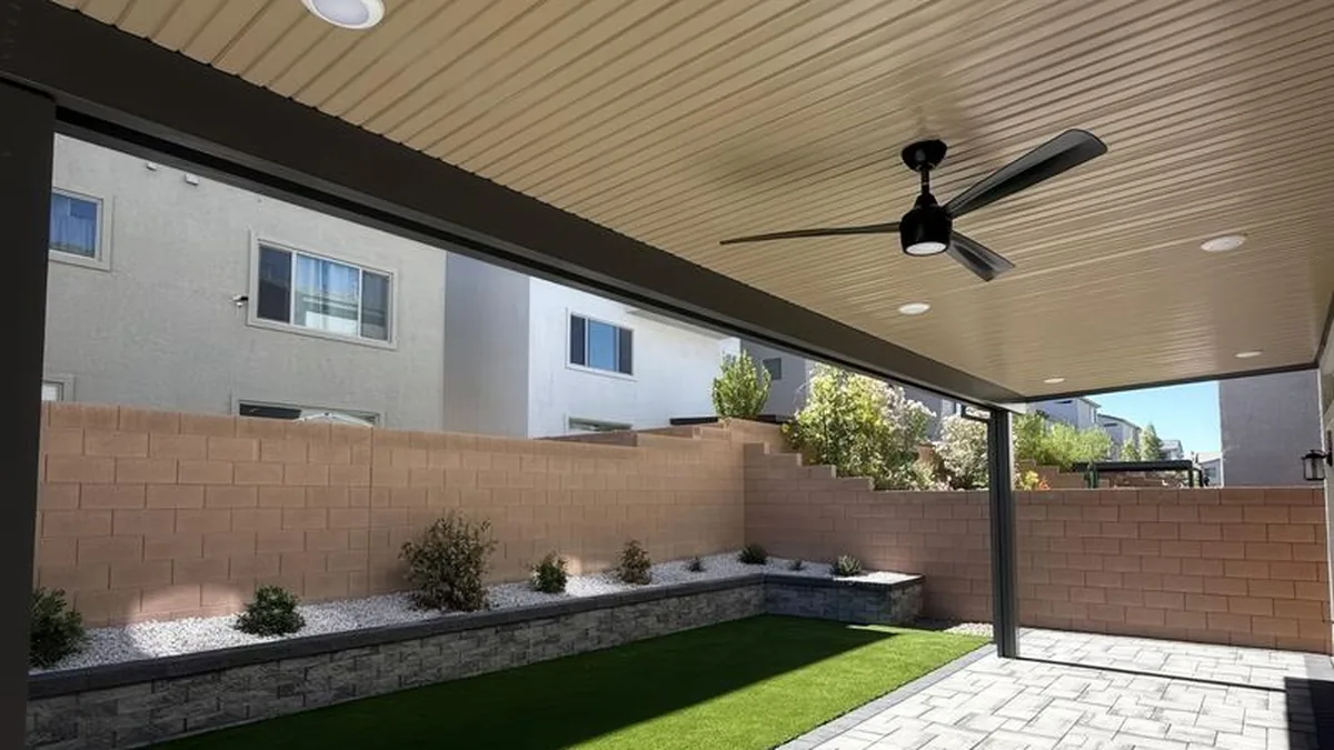 Outdoor patio with a fire feature and a mounted outdoor TV