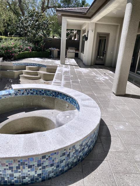 Tiled spa on a travertine deck, a Unique Pavers job in Las Vegas Valley