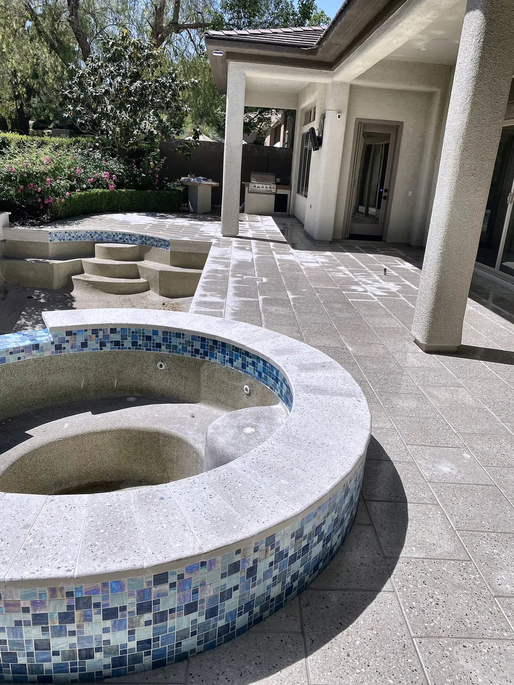 Tiled spa on a travertine deck, a Unique Pavers job in the Las Vegas valley
