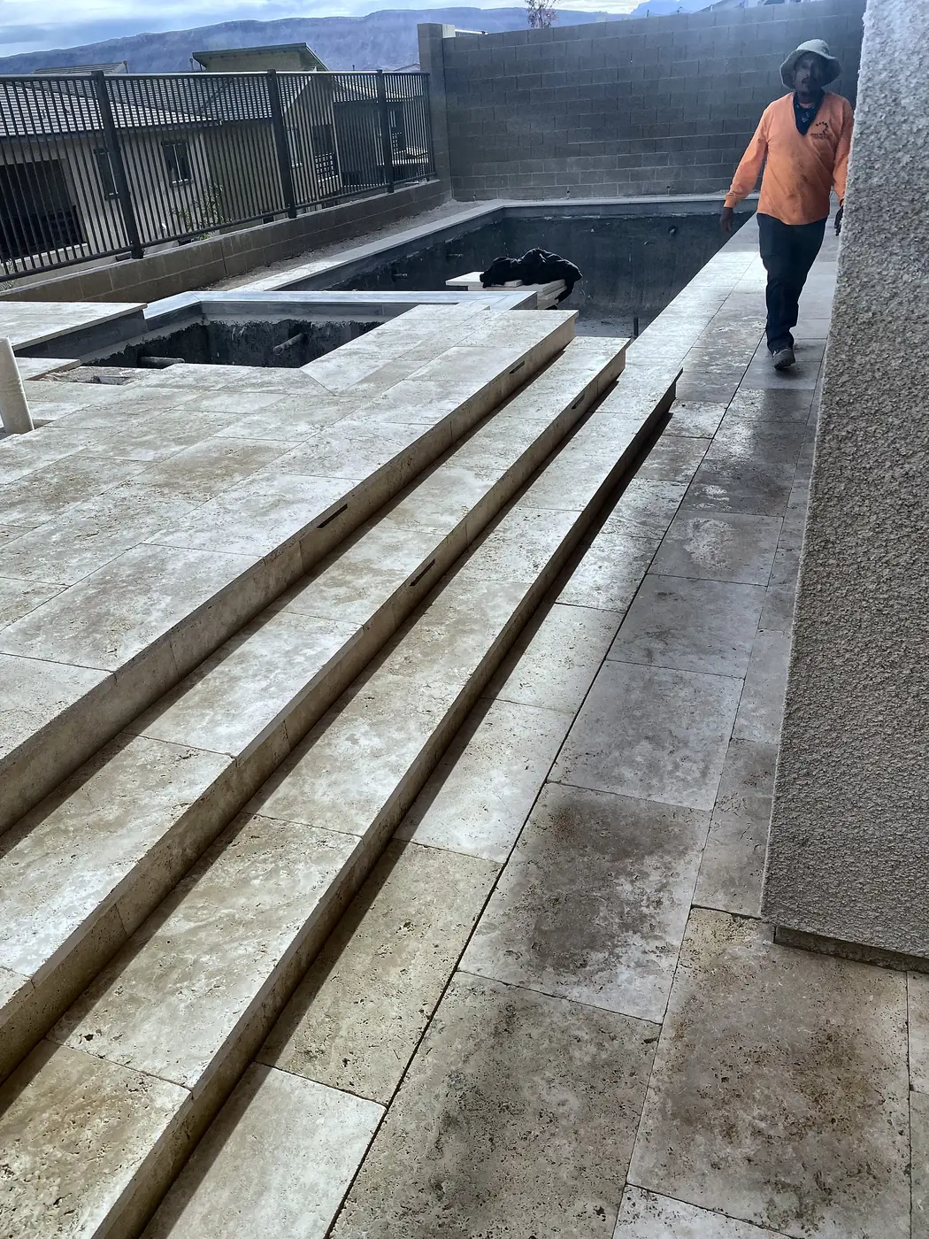 Travertine steps down to the patio, a Unique Pavers job in the Las Vegas valley