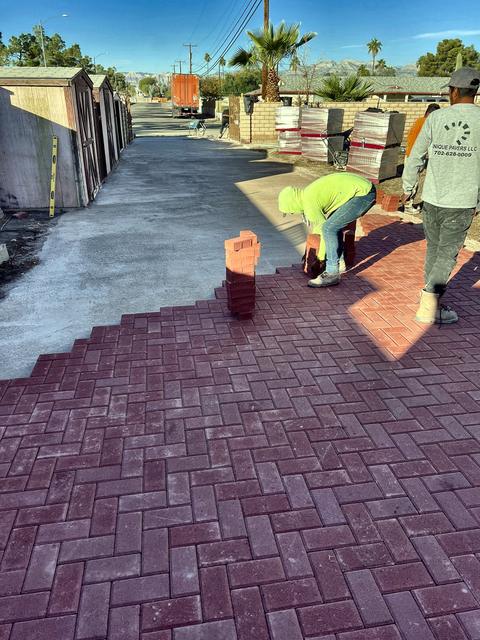 Crew setting the herringbone, a Unique Pavers job in Las Vegas Valley