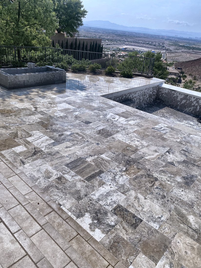 Travertine patio with a raised planter overlooking the Las Vegas valley